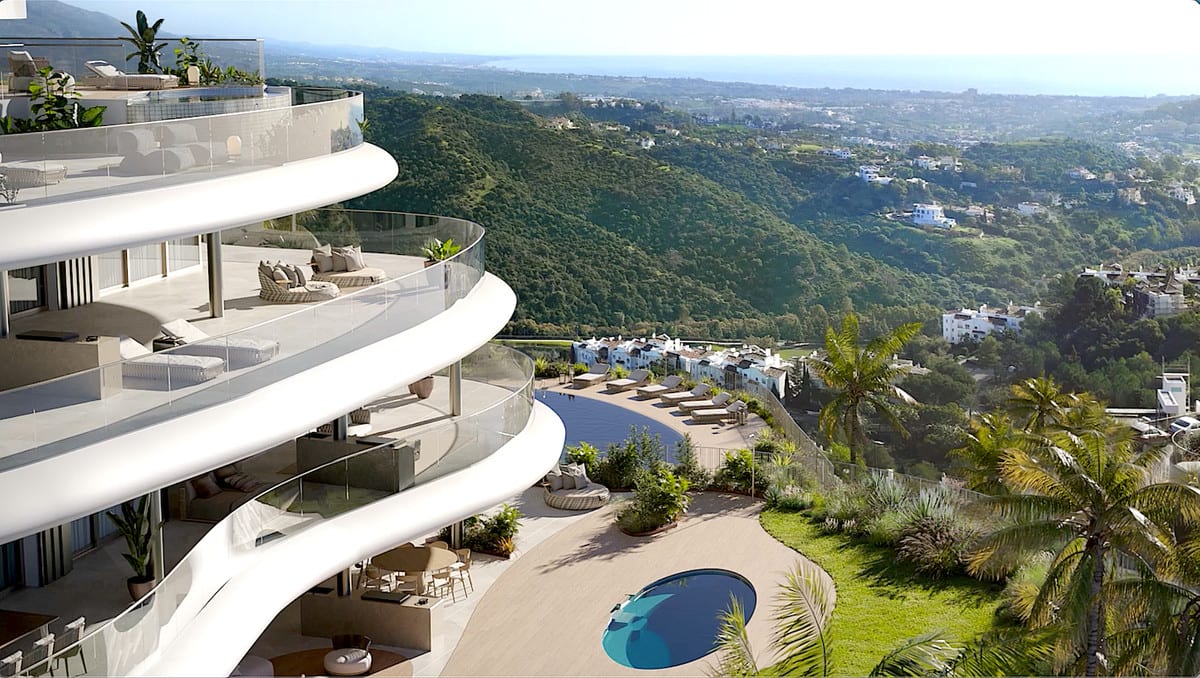 Project visualisation — THE SKY MARBELLA APARTMENTS: Curved façade and terraces overlooking wooded hills.