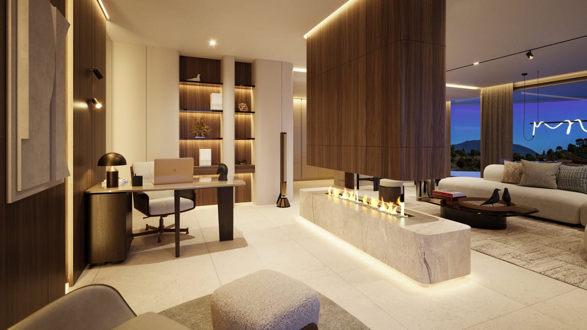 Evening visualisation of THE VIEW MARBELLA PHASE 2 & 3 featuring a workspace, illuminated built-in bookcases, a freestanding double-sided fireplace with stone surround and a seating area.