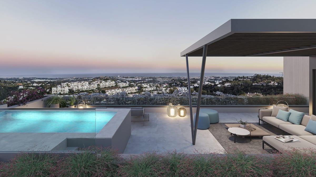 Project visualisation of TIARA with a terrace at dusk, a compact illuminated swimming pool, a glass balustrade, a covered seating area with a lounge sofa and lanterns beneath a steel pergola, and broad views over buildings towards water on the horizon.