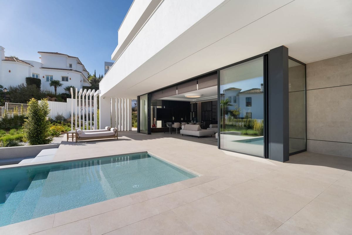 Visualisation of the pool terrace beside open sliding doors to the living area.