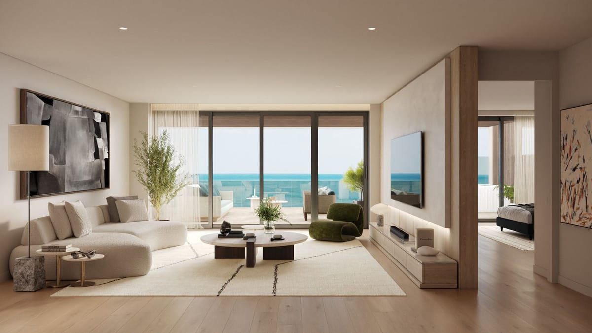 Interior visualisation of UNIQUE INFINITY featuring a bright living room, cream sofa, green armchair, wooden floor, large wall artwork and sliding glass doors opening onto a terrace with the sea visible in the render.