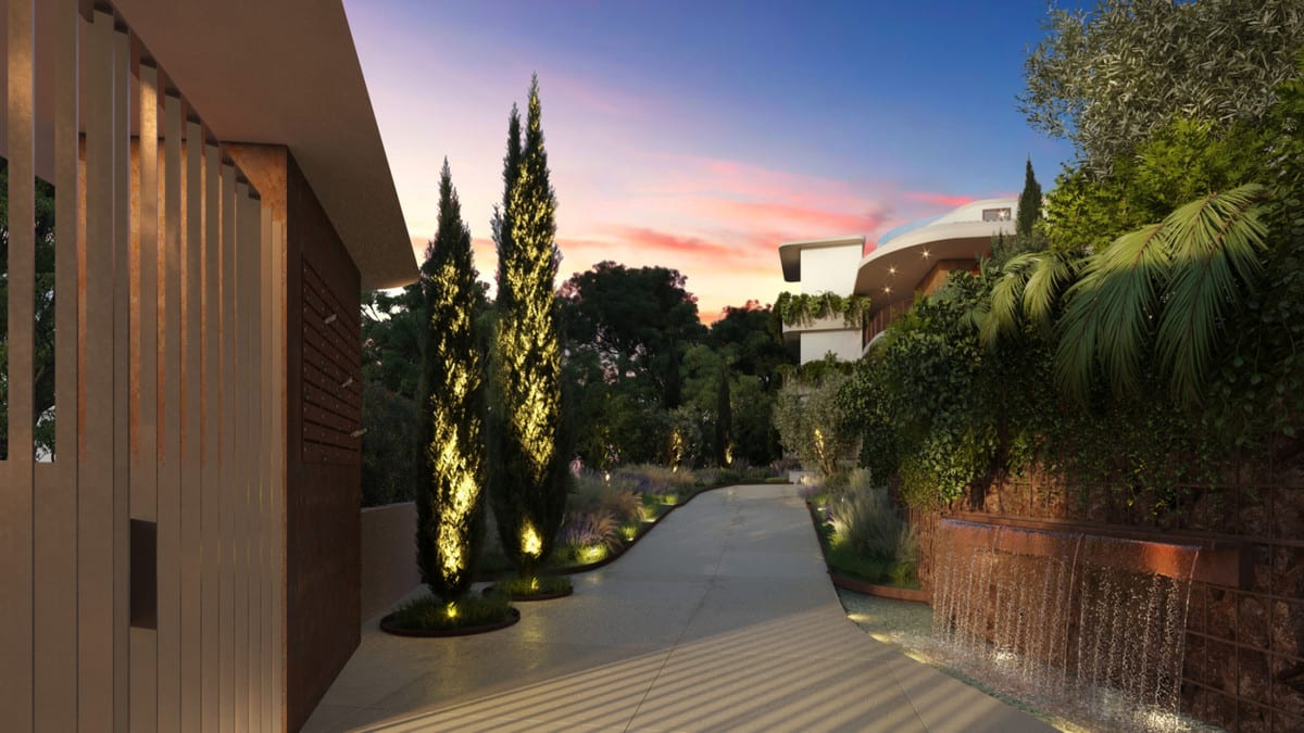 Evening visualisation of VALLEY COLLECTION featuring an illuminated pathway, ground lights by cypresses, a waterfall alongside a corten steel wall, and a colourful twilight sky.