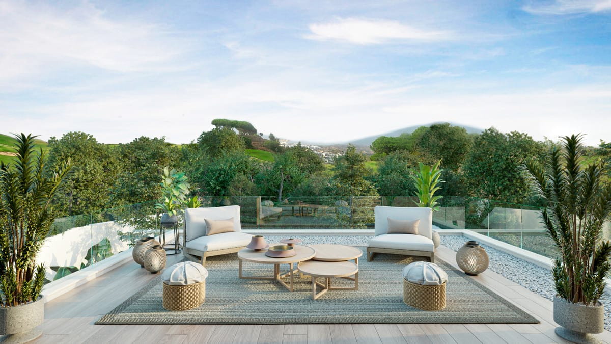 Project visualisation of VILLA AITANA with a terrace featuring light timber flooring, a glass balustrade, two light low seating pieces, nesting round tables, woven pouffes, lantern-shaped decoration and large tropical potted plants, with a green hilly landscape in the background.