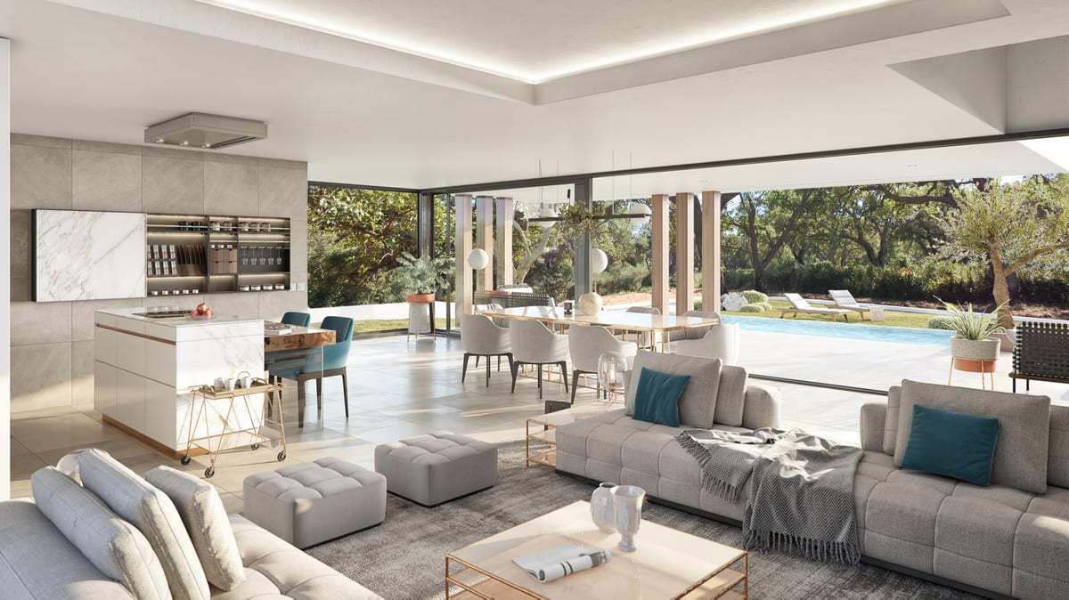 The kitchen, dining table and seating area form one open space with broad glazing towards the terrace and pool.