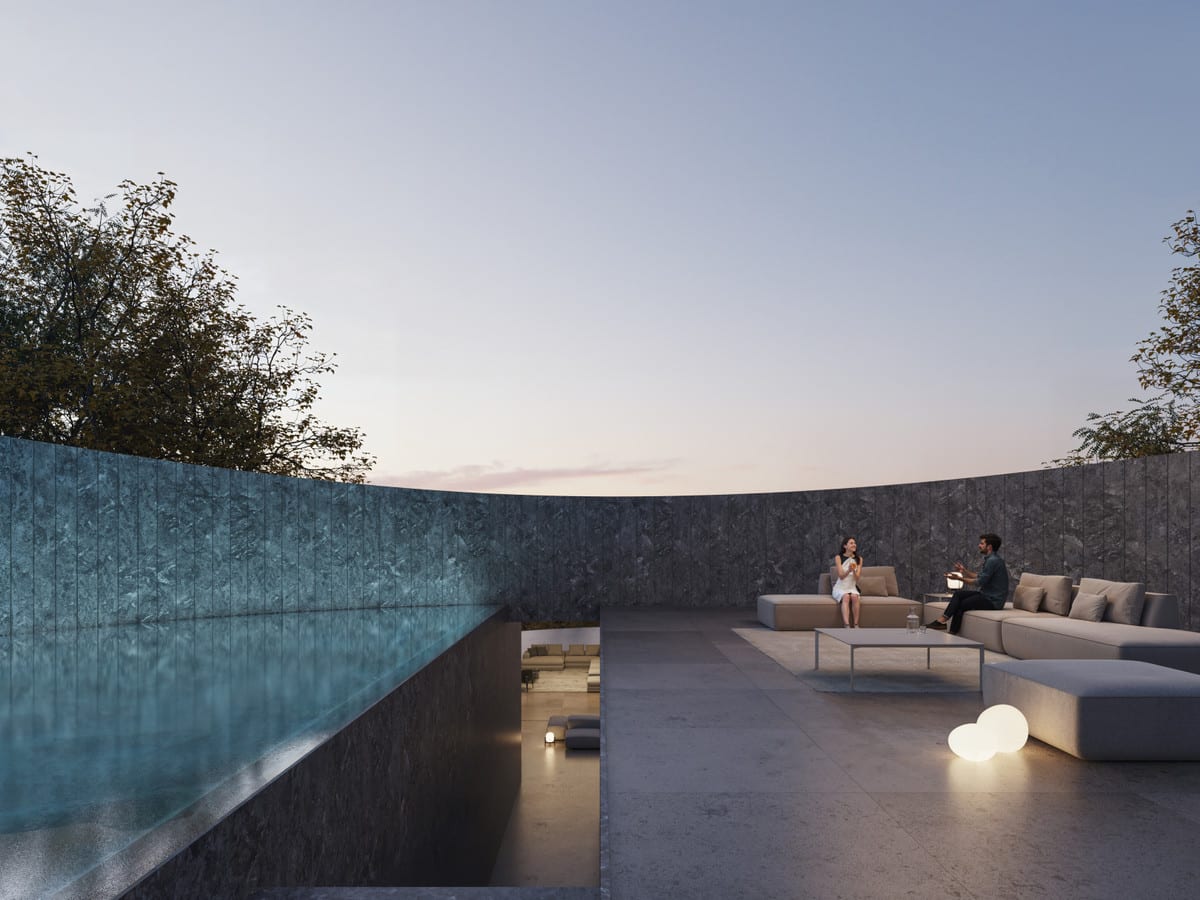 Visualisation of VILLA NOON’s outdoor lounge at dusk, with grey sofas, round lamps and a curved dark wall.