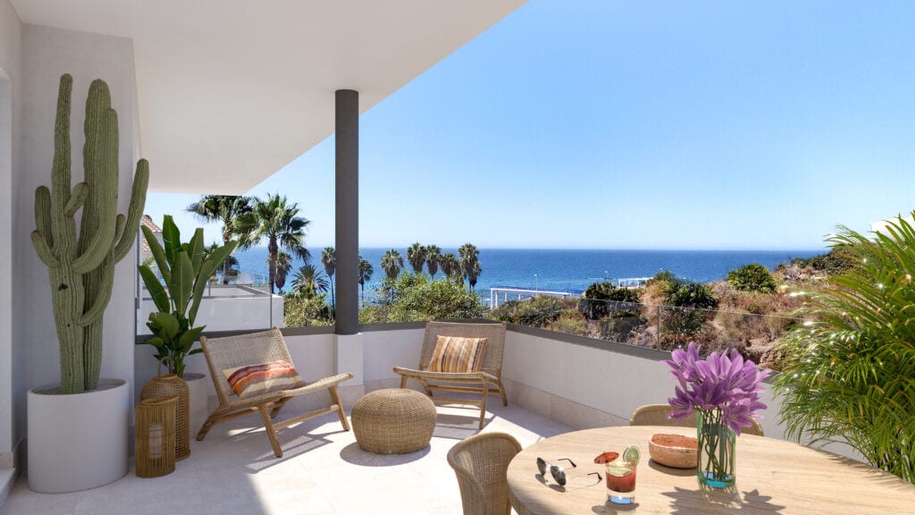 Project visualisation of the terrace at VITTA MARINA with two wooden loungers, a rattan pouffe, a small round table with drinks, a large potted cactus and sea views.