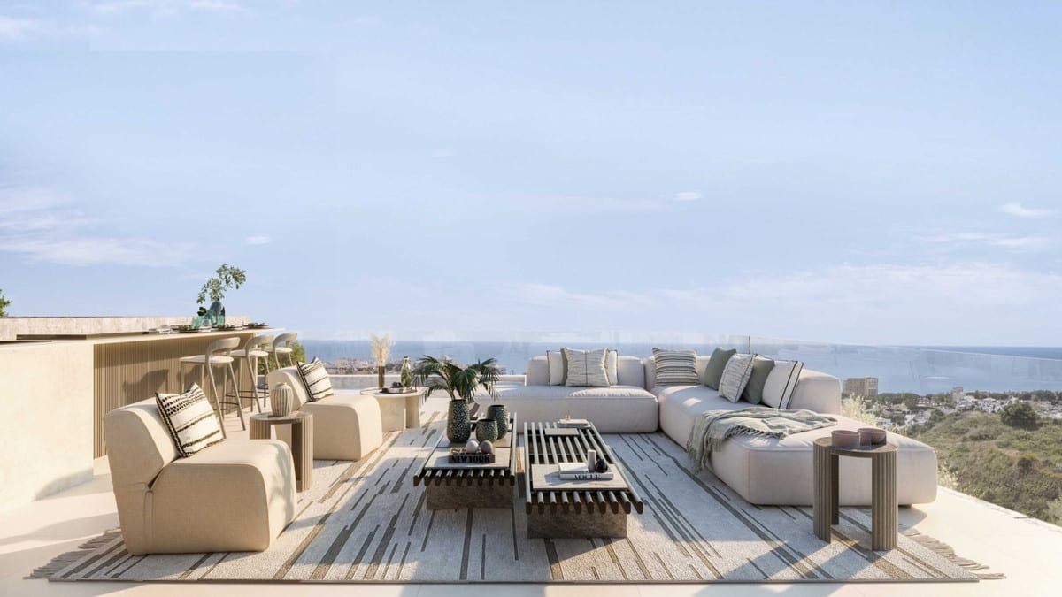Project visualisation of ZEW ELVIRIA with a spacious outdoor terrace, light lounge sofas, bar stools and a glass balustrade with sea views.