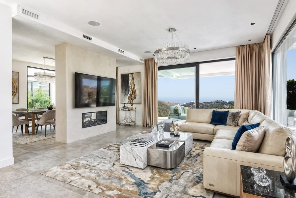 ZOE LUXE: Living area with sofas and large windows.