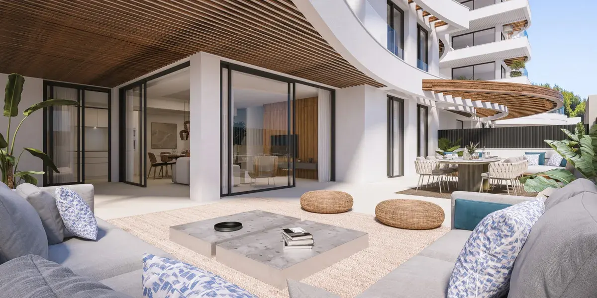 Project visualisation of MARINA GOLDEN BAY showing a spacious outdoor area, grey lounge sofa with blue cushions, low marble coffee table, rattan poufs, glass sliding doors leading indoors and a curved wooden slatted ceiling.